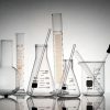 A laboratory glassware setup with interconnected tubes and valves used for chemical processes, representing proper maintenance and cleaning standards in a lab environment.