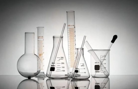 A laboratory glassware setup with interconnected tubes and valves used for chemical processes, representing proper maintenance and cleaning standards in a lab environment.
