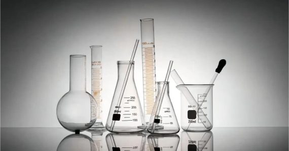 A laboratory glassware setup with interconnected tubes and valves used for chemical processes, representing proper maintenance and cleaning standards in a lab environment.