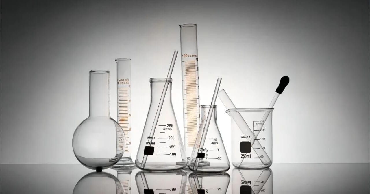A laboratory glassware setup with interconnected tubes and valves used for chemical processes, representing proper maintenance and cleaning standards in a lab environment.